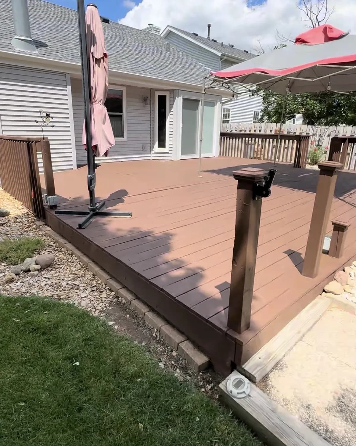 Kim's Loves Park deck after refinishing, with a rich, even stain and clean railings