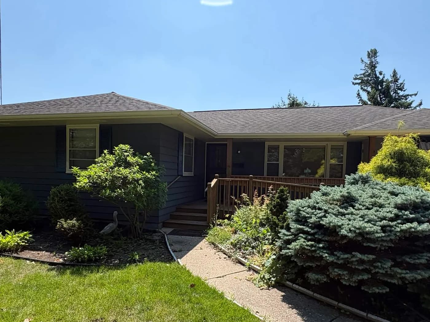 Pete's Rockford home before repainting, with sun faded siding and cracking paint